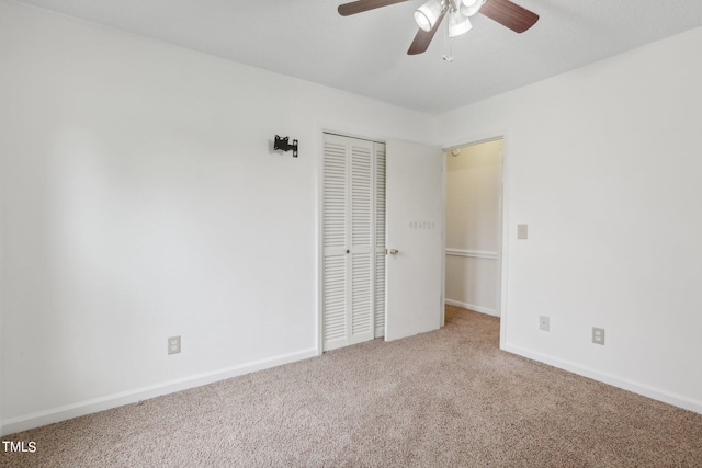 unfurnished bedroom with ceiling fan, a closet, and carpet flooring