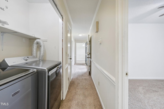 laundry area featuring ceiling fan, light colored carpet, and separate washer and dryer