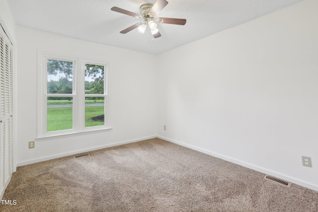 carpeted empty room with ceiling fan