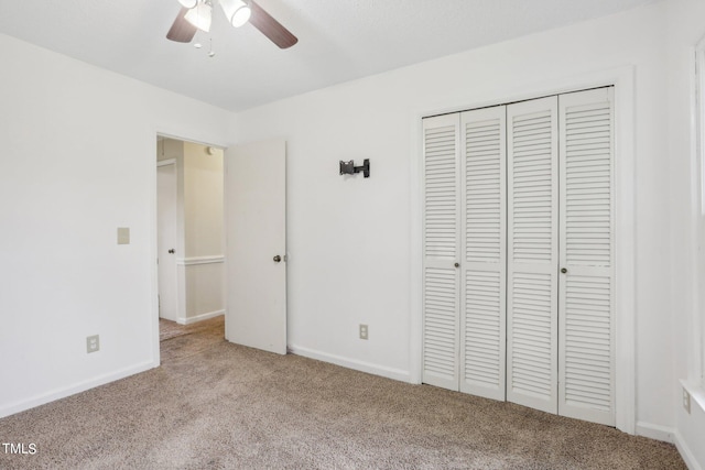 unfurnished bedroom featuring ceiling fan, light colored carpet, and a closet