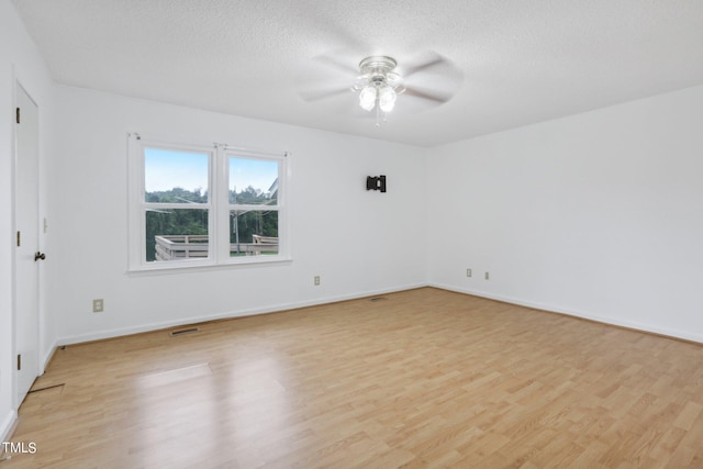 unfurnished room featuring ceiling fan, a textured ceiling, and light wood-type flooring