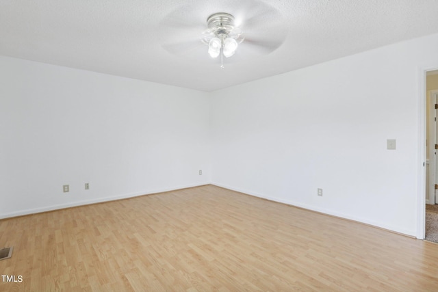 unfurnished room with ceiling fan, a textured ceiling, and light hardwood / wood-style flooring