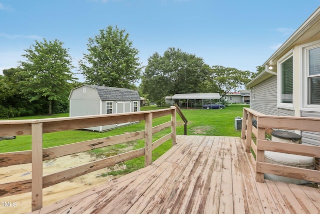 wooden deck with a lawn and a shed