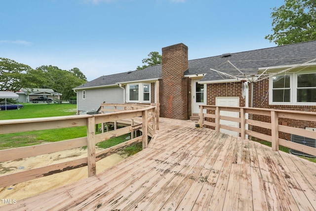 wooden terrace with a lawn