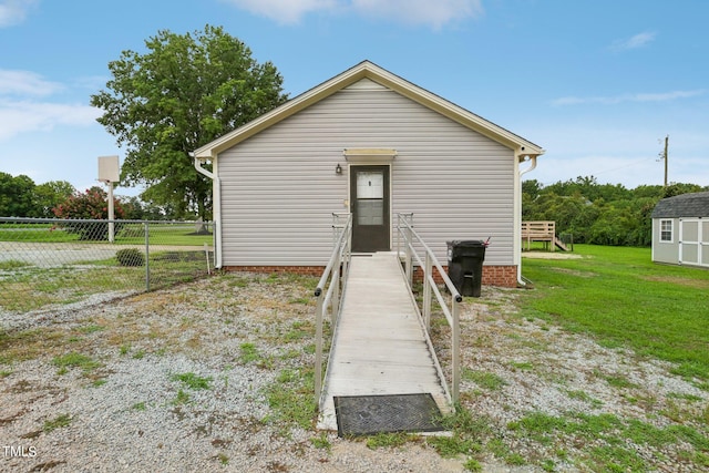 back of house with a lawn