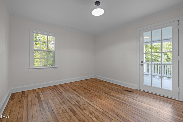 unfurnished room featuring wood-type flooring and ornamental molding