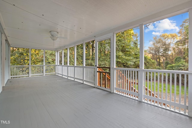 unfurnished sunroom with ceiling fan