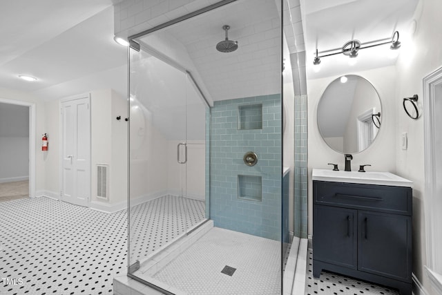 bathroom featuring walk in shower, vanity, and tile patterned floors