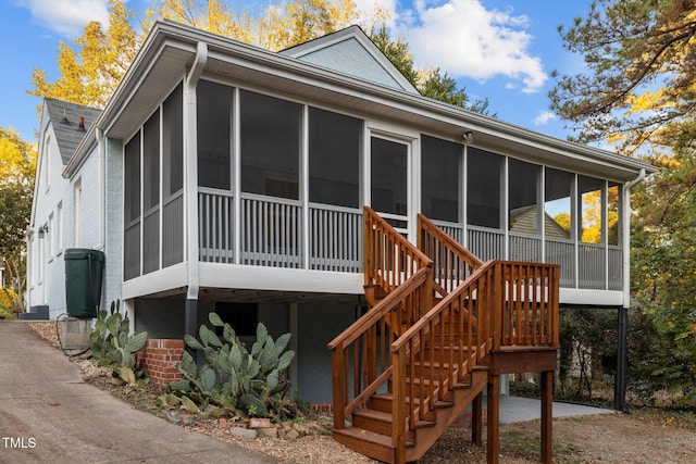 rear view of house with a sunroom