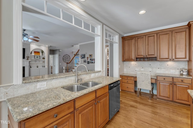 kitchen featuring stainless steel dishwasher, light stone counters, backsplash, ceiling fan, and a sink