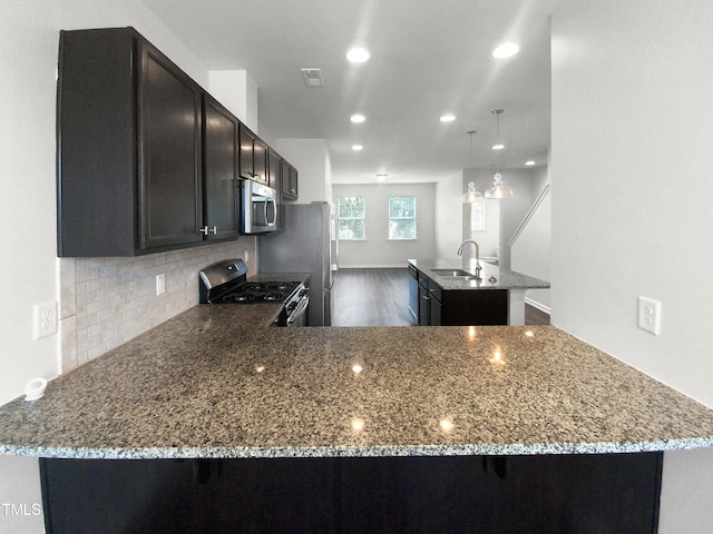 kitchen featuring kitchen peninsula, sink, and stainless steel appliances