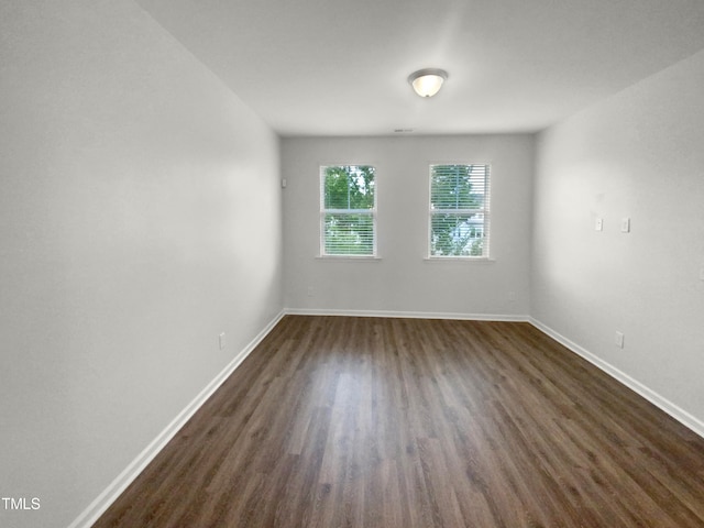 spare room with dark hardwood / wood-style floors