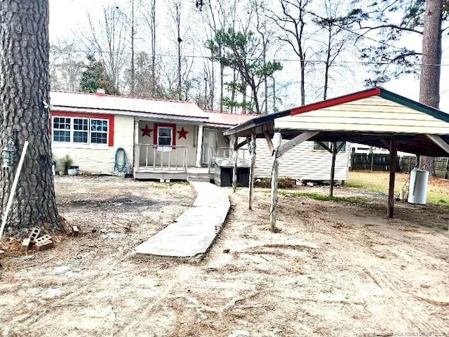 view of front of property featuring a carport and a porch