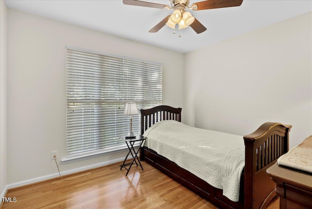 bedroom with hardwood / wood-style flooring and ceiling fan