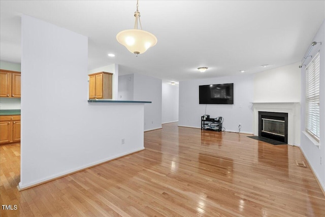 unfurnished living room featuring light wood-type flooring