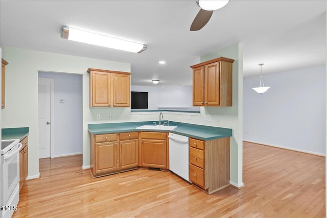 kitchen featuring light wood-type flooring, white appliances, ceiling fan, sink, and decorative light fixtures