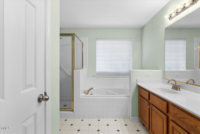 bathroom featuring vanity, a healthy amount of sunlight, and separate shower and tub