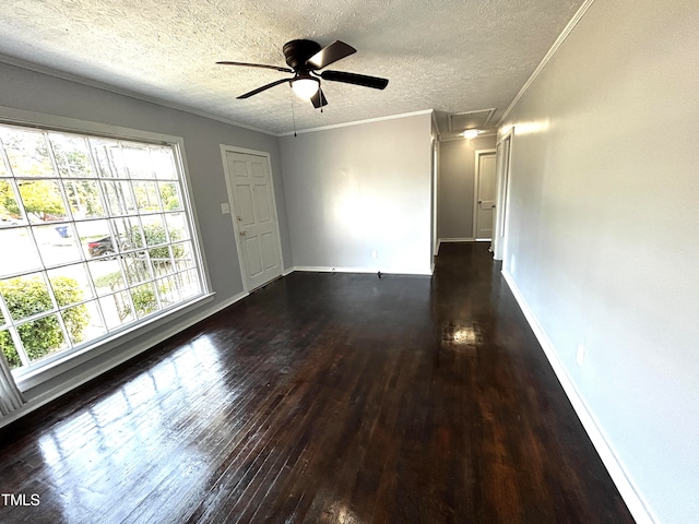 unfurnished room with a textured ceiling, ornamental molding, dark hardwood / wood-style floors, and ceiling fan