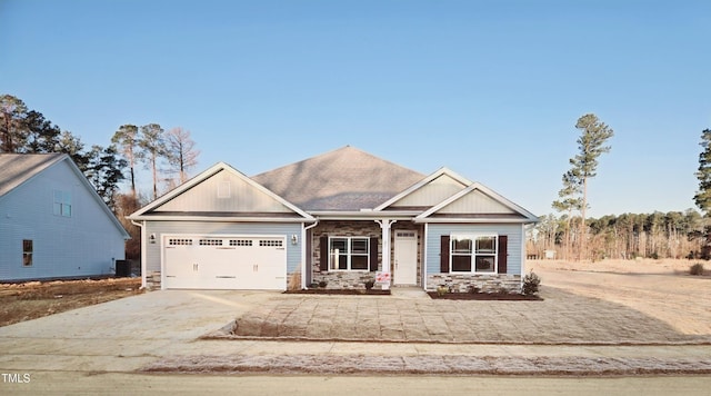 craftsman-style house with a garage and central AC unit