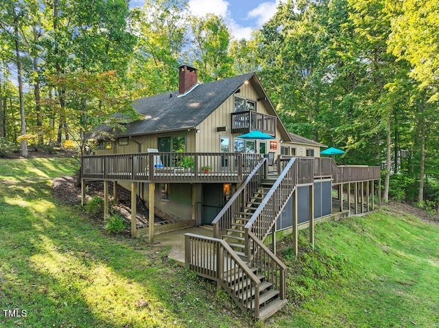 back of house with a wooden deck and a yard