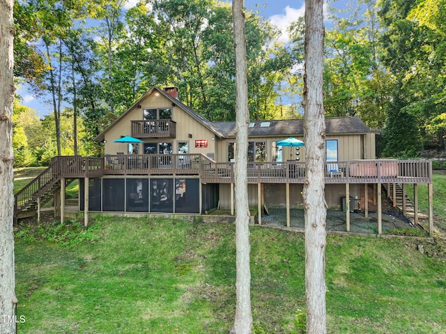 rear view of property featuring a lawn, a deck, and central AC unit