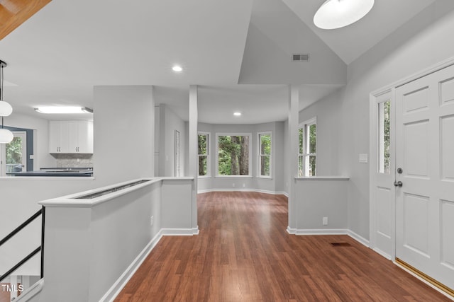 foyer entrance featuring a healthy amount of sunlight, visible vents, and wood finished floors