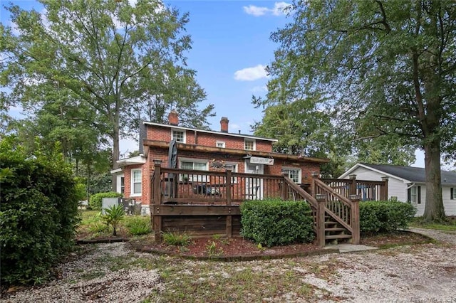 rear view of house with a wooden deck