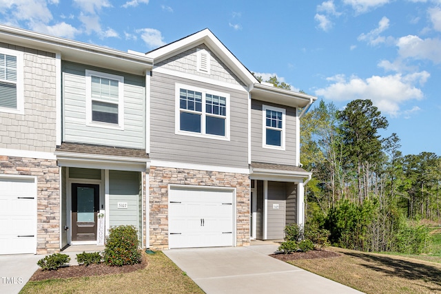 townhome / multi-family property with a front yard and a garage