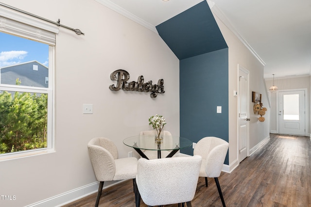 dining area with dark wood-type flooring and crown molding