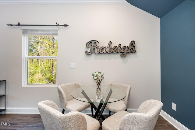 dining area featuring vaulted ceiling and dark hardwood / wood-style floors