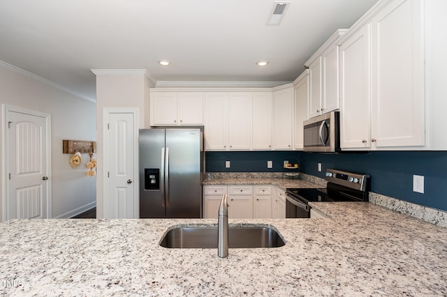 kitchen with stainless steel appliances, white cabinets, crown molding, and sink