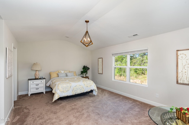 carpeted bedroom featuring a notable chandelier and lofted ceiling