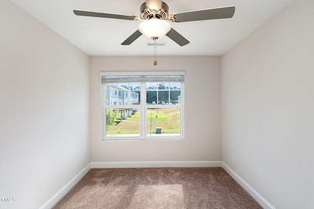 carpeted spare room featuring ceiling fan