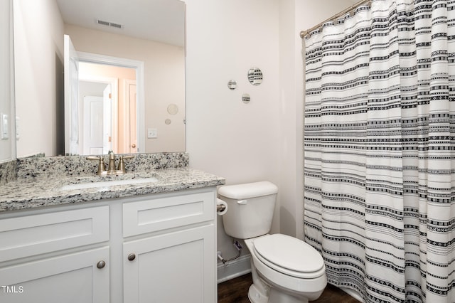 bathroom featuring wood-type flooring, vanity, and toilet