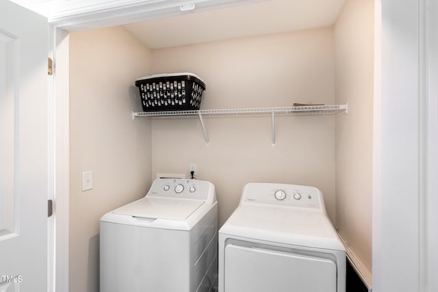 clothes washing area with washer and dryer