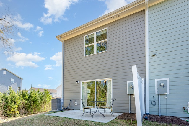 back of property featuring a patio and central AC