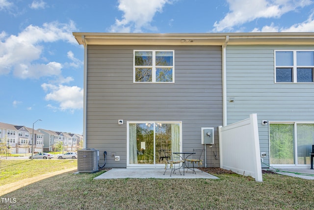 back of property featuring central AC unit, a yard, and a patio