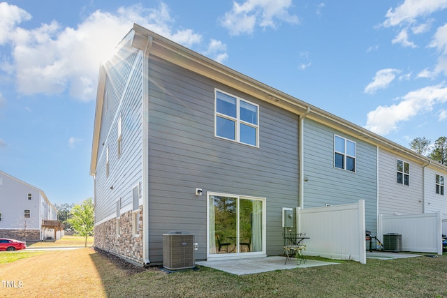 back of house with a patio, central AC, and a yard