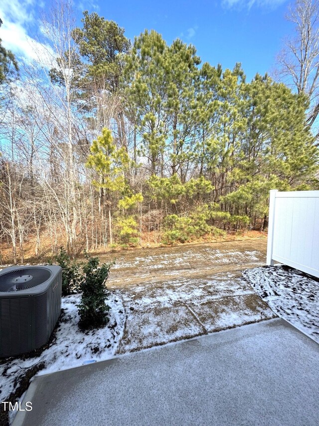 snow covered patio featuring central AC