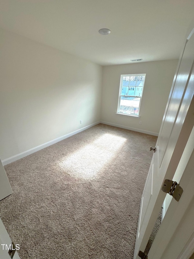 unfurnished room featuring carpet