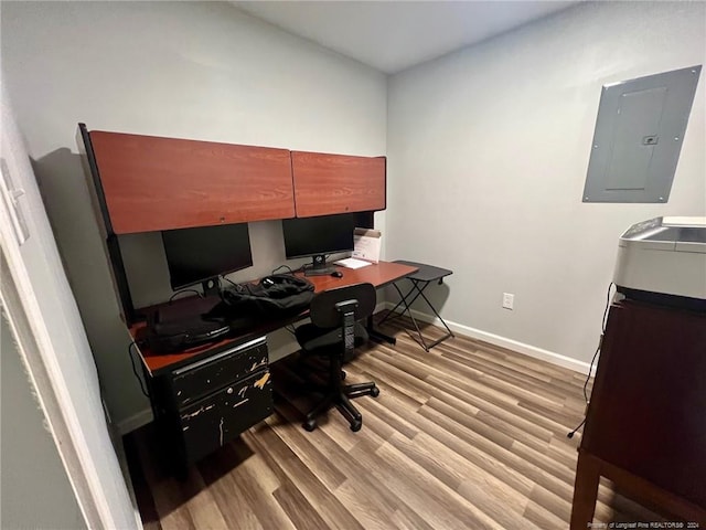 office with light hardwood / wood-style floors and electric panel