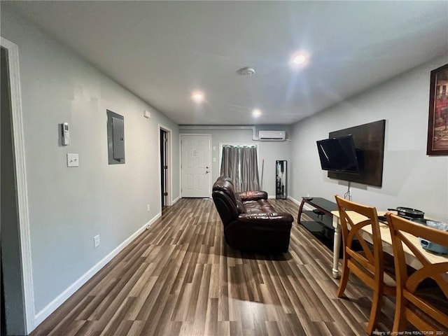 interior space with electric panel, hardwood / wood-style flooring, and a wall mounted air conditioner