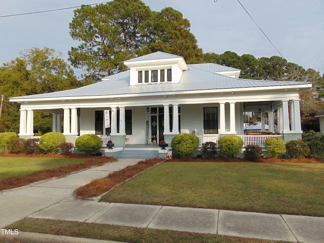 view of front facade with covered porch and a front lawn