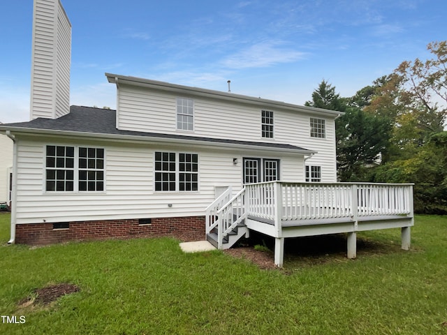 rear view of property with a lawn and a deck