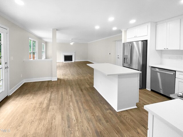 kitchen featuring white cabinetry, dark wood-type flooring, appliances with stainless steel finishes, and a kitchen island