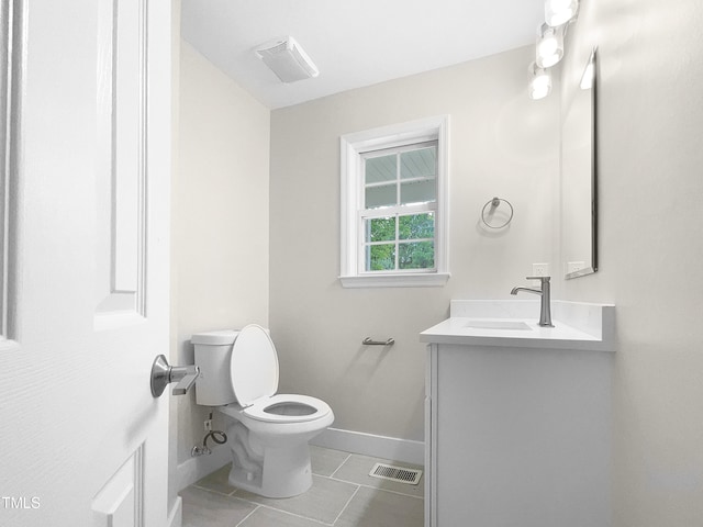 bathroom with tile patterned floors, vanity, and toilet