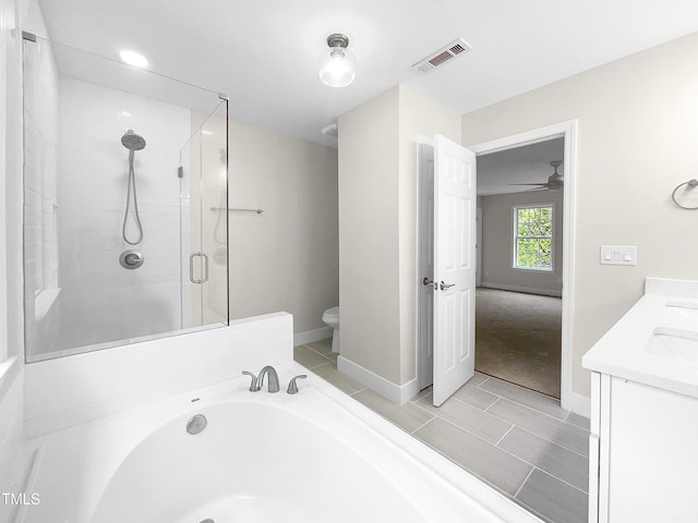 full bathroom featuring vanity, toilet, ceiling fan, and plus walk in shower