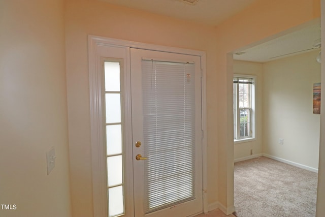 entryway featuring light carpet