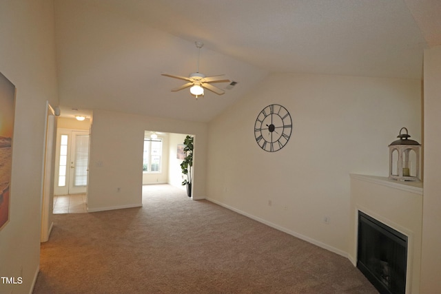 unfurnished living room featuring ceiling fan, light carpet, and lofted ceiling