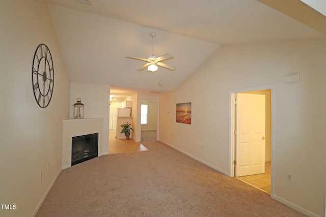 unfurnished living room featuring light colored carpet, ceiling fan, and lofted ceiling